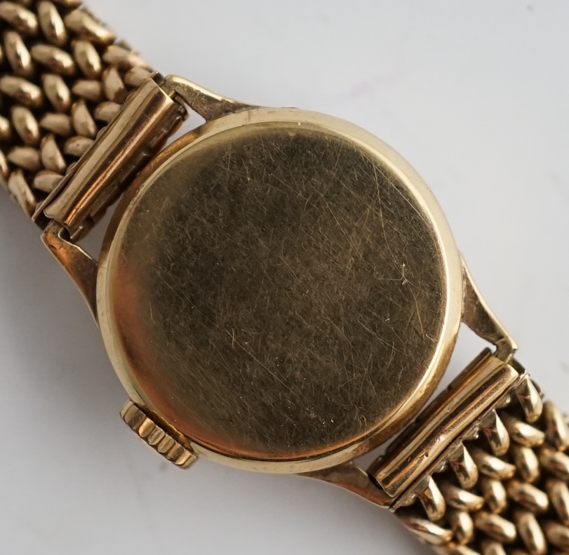 A lady's 9ct gold Omega manual wind wrist watch, on an associated 9ct bracelet, with Arabic and dot numerals, case diameter 20mm, overall length 16.7cm, gross weight 30 grams., no box or papers, with spare bracelet parts